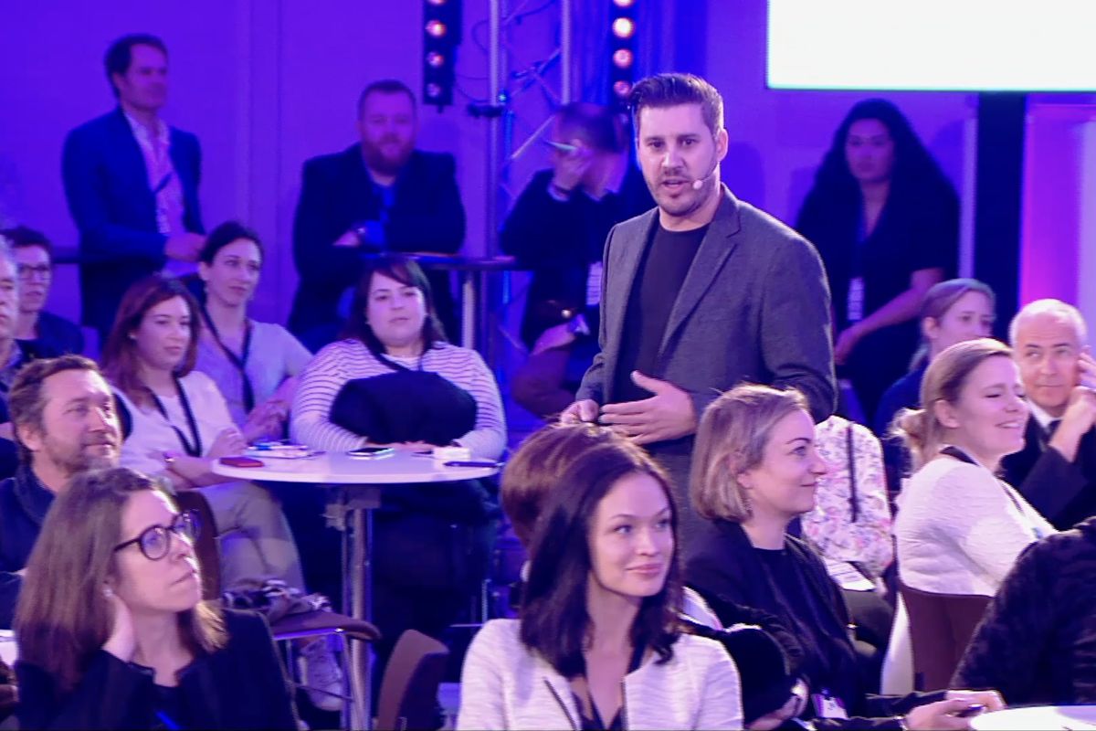 Ben speaking from within the audience at a conference